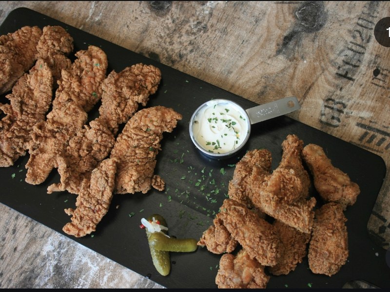 Hand-battered tenders & wings on a sharing board
